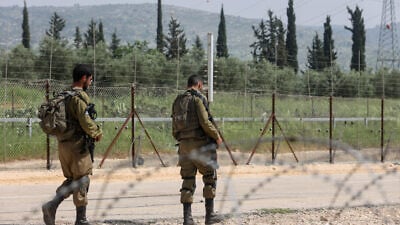 IDF soldiers stand guard near a hole in the security fence near Mevo Horon as Palestinians try to cross into Green Line Israel from Samaria, April 10, 2022. Credit: Flash90.