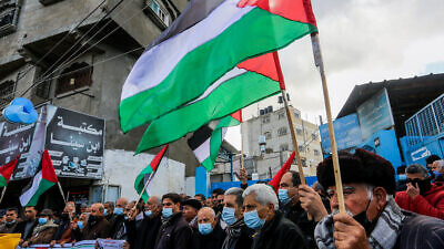 Palestinians protest the reduction in food provisions by the U.N. Relief and Works Agency for Palestine Refugees (UNRWA) in Khan Yunis, in the southern Gaza Strip, on Jan. 20, 2021. Photo by Abed Rahim Khatib/Flash90.