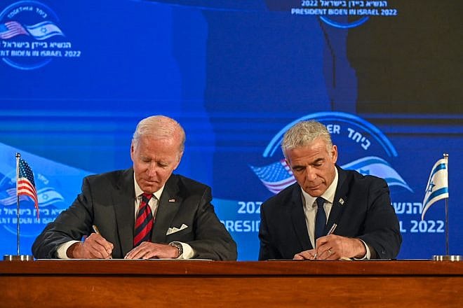U.S. President Joe Biden and Israeli Prime Minister Yair Lapid sign the “Jerusalem U.S.-Israel Strategic Partnership Joint Declaration,” which states that America will “use all elements of its national power" to prevent Iran from acquiring nuclear weapons. Credit: Kobi Gideon/GPO