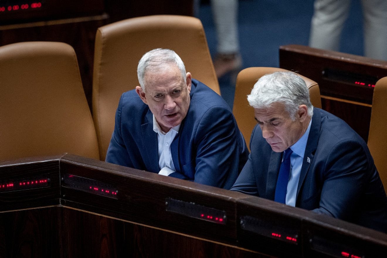 Foreign Minister Yair Lapid and Defense Minister Benny Gantz attend a plenum session at the Knesset in Jerusalem on June 20, 2022. Photo by Yonatan Sindel/Flash90.