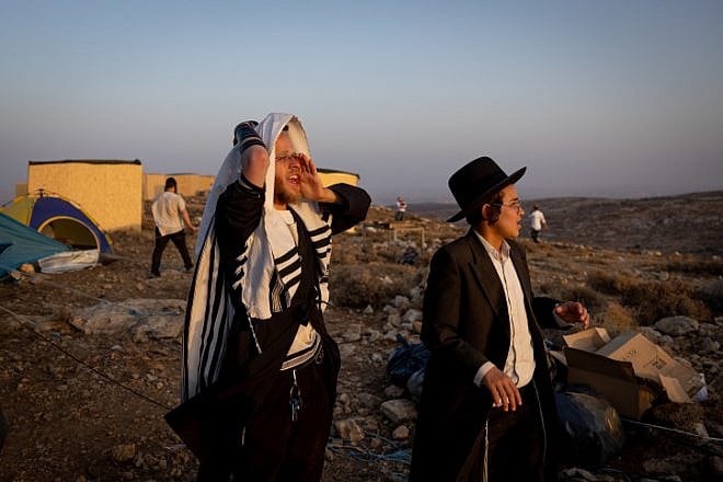 Ultra-Orthodox, or haredi, Jewish men at the Derech Emunah outpost in Judea and Samaria, on Aug.16, 2022. Photo by Yonatan Sindel/Flash90.