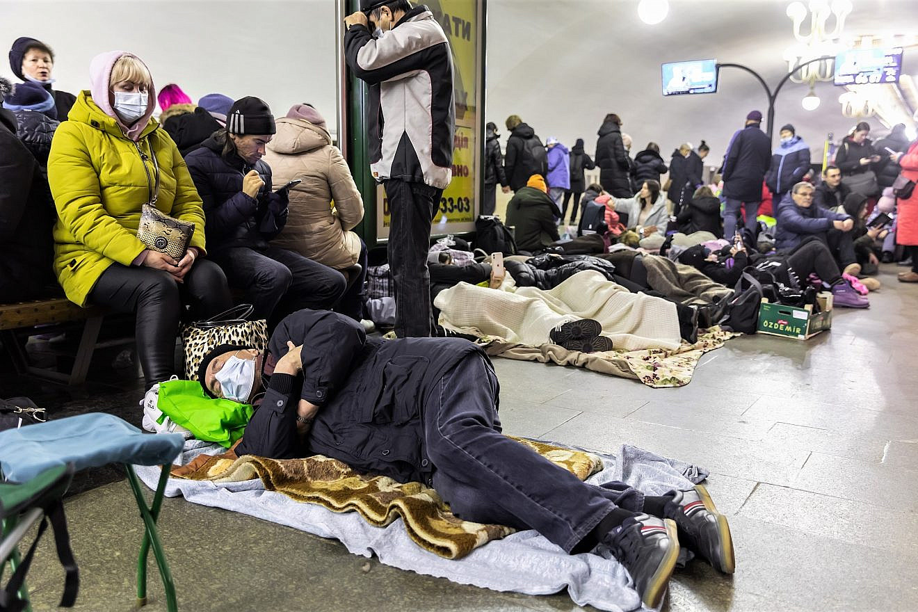 Ukrainians take refuge in a subway station that serves as a shelter for thousands of people during a rocket and bomb attack by Russian forces, February 2022. Credit: Drop of Light/Shutterstock.
