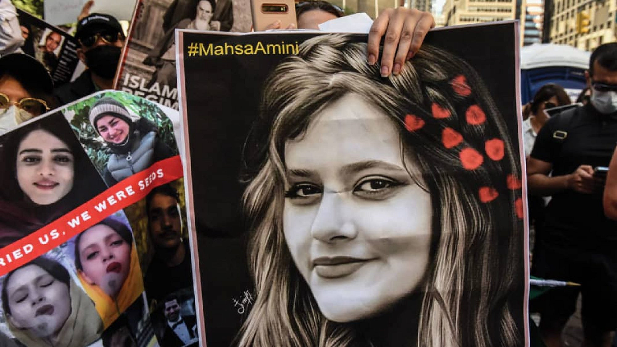 A protester holds a picture of Mahsa Amini, the Kurdish-Iranian woman whose 2022 death in the custody of Iran’s “morality police” sparked widespread unrest in the Islamic Republic. Source: Twitter.