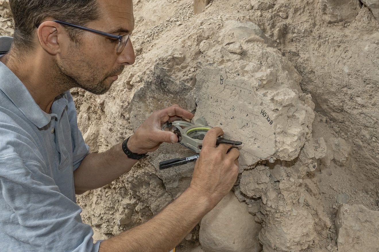 A researchers takes measurements at an archaeological site in Israel. Credit: Tel Aviv University.