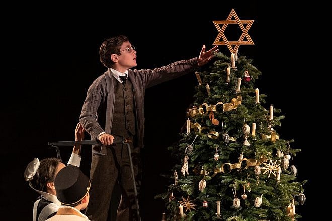 A scene from the play "Leopoldstadt," which opens in 1899 at a family Christmas party, where one of the children places a large Star of David atop the tree. Credit: "Leopoldstadt."