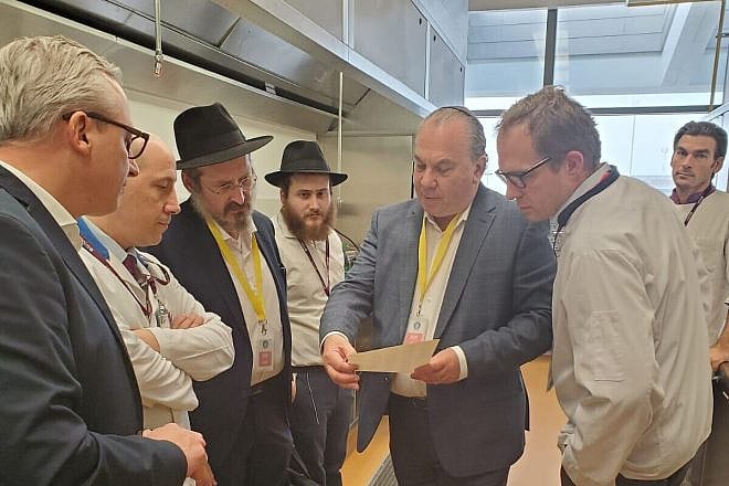 Rabbi Marc Schneier (center) with Rabbi Mendy Chitrik (third left) looking on and behind him his son, Rabbi Eliyahu Chitrik, in Doha, Qatar. Courtesy.