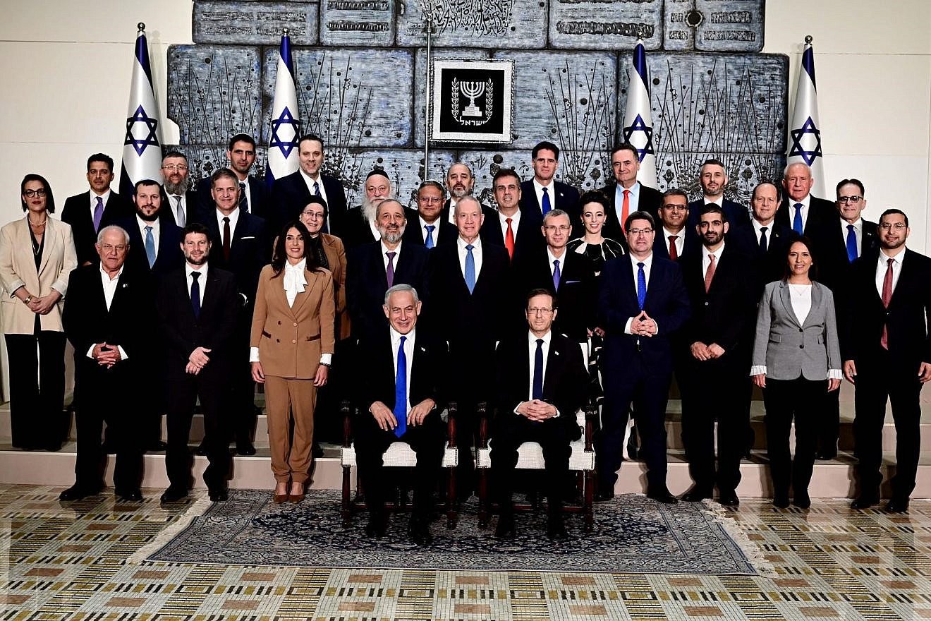 Israeli President Isaac Herzog and Israeli Prime Minister Benjamin Netanyahu sit at the center of the traditional photograph of the incoming government at the President's Residence in Jerusalem, Dec. 29, 2022. Credit: Avi Ohayon/GPO.