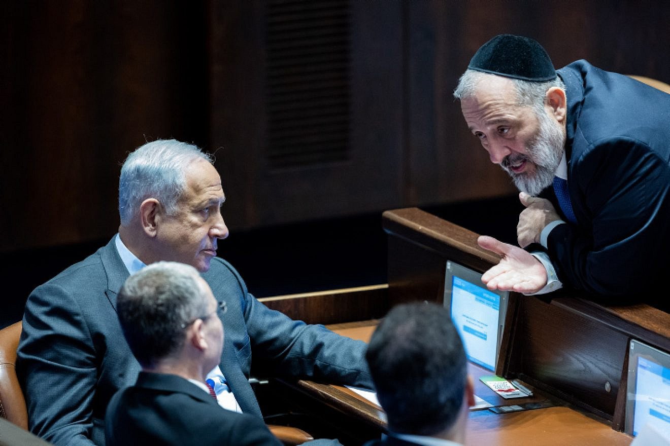 Israeli Prime Minister Benjamin Netanyahu speaks with Shas chairman Aryeh Deri in the Knesset. Photo by Yonatan Sindel/Flash90.