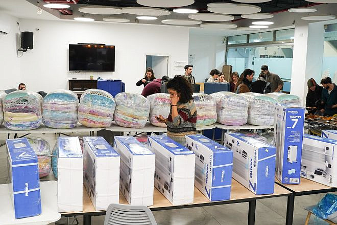 More than 200 volunteers brave stormy winter conditions to deliver portable heaters, blankets and prepared meals to 300 elderly and Holocaust survivors living in Jerusalem, as part of the Colel Chabad’s “Get Chesed” youth program, Feb. 7, 2023. Credit: Eli Mandelbaum.