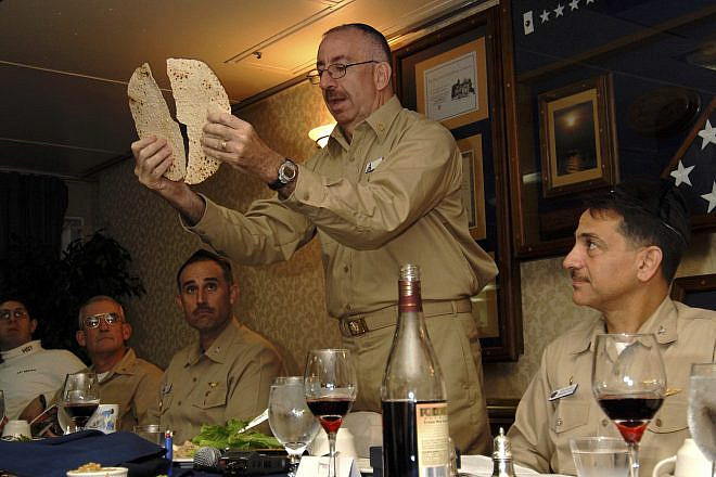 Herman “Herm” Shelanski (far right), then skipper of the squadron on the “USS John C. Stennis,” celebrating Passover in 2008 on the ship with chaplain Rabbi Irving Elson (holding matzah) and executive officer Capt. Ron Reis (next to the left). Credit: Courtesy of Vice Adm. (Ret.) Herman Shelanski.