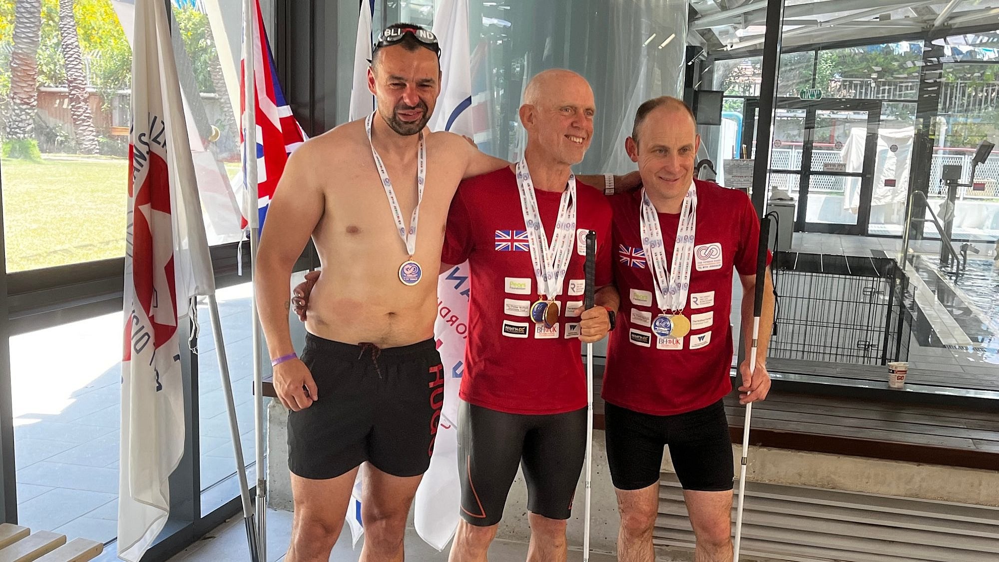 Craig Lundberg (right) receives a swimming medal in the visually impaired category. Courtesy.