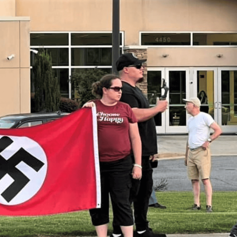 Protesters, including those belonging to neo-Nazi groups, hold swastika flags outside a synagogue in Georgia. Credit: Combat Antisemitism Movement.