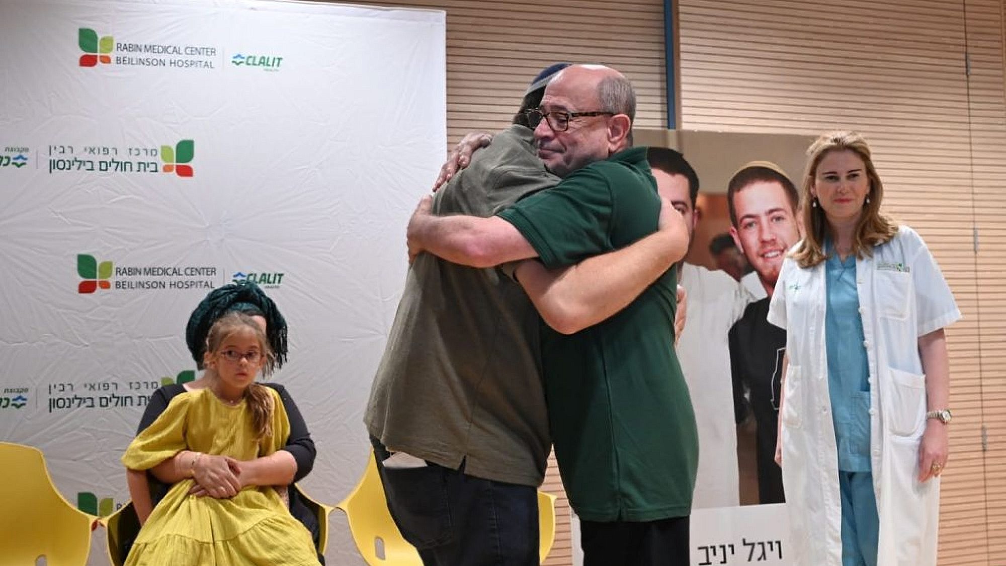 Shalom Yaniv (left), father of terror victims Hallel and Yagel Yaniv, hugs Ron Carmeli, who received a donated cornea, at Beilinson Hospital in Petach Tikvah, June 18, 2023. Photo by Yossi Zeliger/TPS.