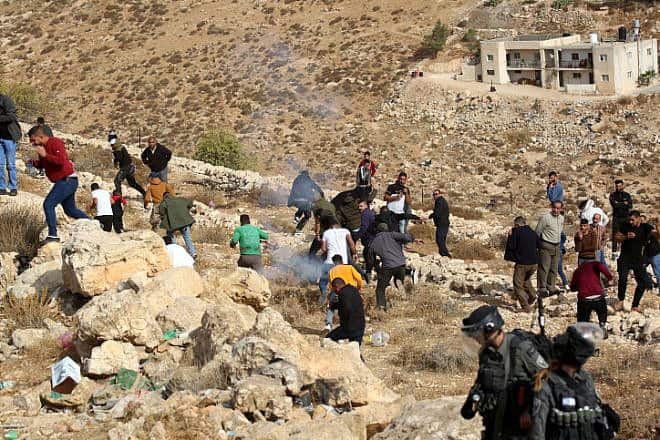 Palestinians clash with Israeli security forces as a bulldozer demolishes a Palestinian house in  Hebron, Oct. 25, 2022. Photo by Wisam Hashlamoun/Flash90.