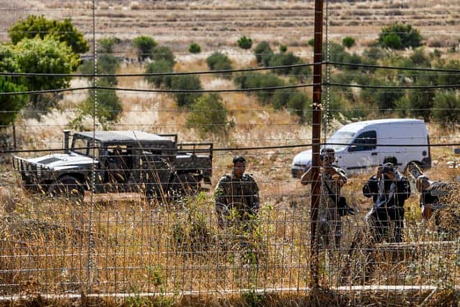 Lebanese soldiers and Hezbollah fighters taking pictures during a fire that spread from the Lebanese side of the border to the Israeli side of the border in Kibbutz Malkia, northern Israel, July 28, 2023. Photo by Ayal Margolin/Flash90.
