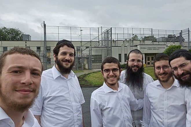 Rabbi Yisroel Baumgarten (left), a volunteer for the Aleph Institute who visits prisons ahead of the the High Holidays, with other volunteers gathered for a training course at the Federal Correctional Institution in Danbury, Conn. Credit: Courtesy of Rabbi Yisroel Baumgarten.