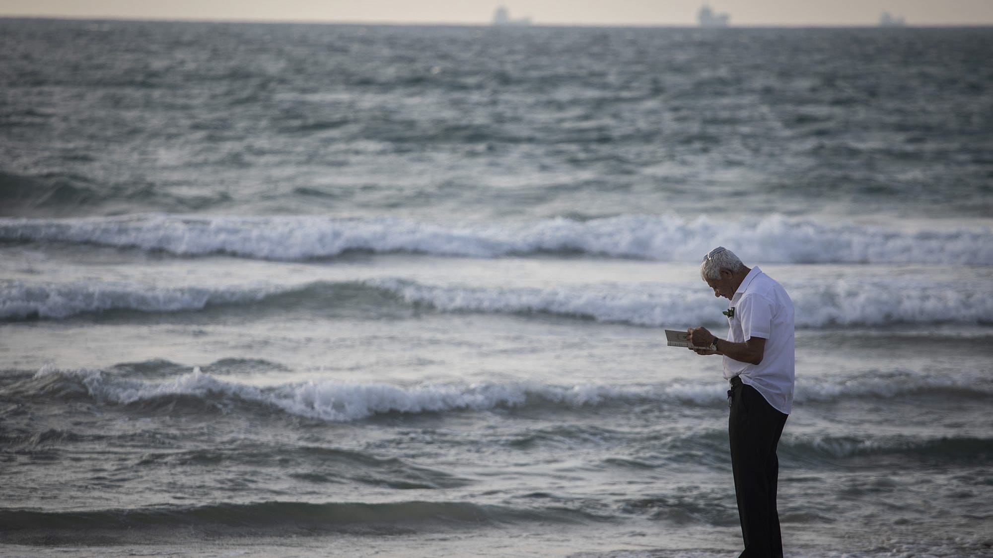 Performing Tashlich overlooking the beach in Kiryat Yam, a suburb outside of Haifa, on Sept. 30, 2019. Photo by Hadas Parush/Flash90.