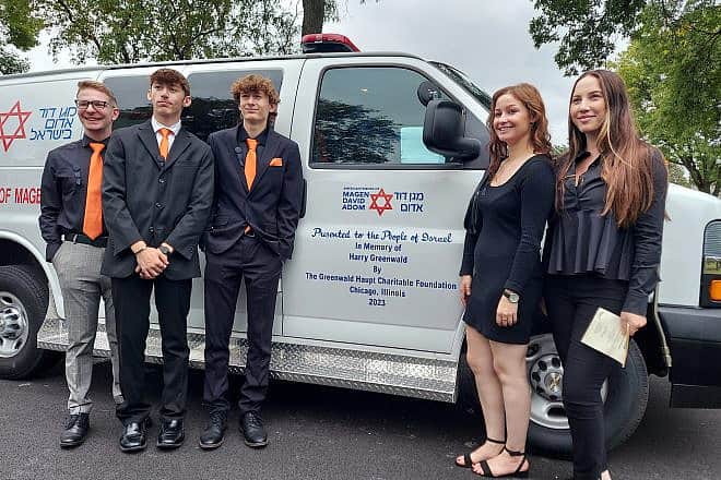 (From left) Zachary, Trevor, Myles, Rebecca and Gabrielle in front of an ambulance dedicated in honor of their grandfather Harry Greenwald, at the 93-year-old's funeral, Sept. 9, 2023. Credit: American Friends of Magen David Adom.