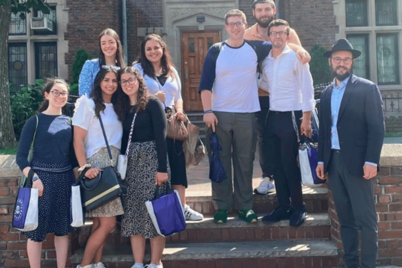 From left: At Chabad Lubavitch World Headquarters in Brooklyn, N.Y. are (front row) Executive Fellows Adina Peck; Yael Lovett; Rena Rush; Rabbi Motti Seligson, director of media relations for Chabad; (back row) Executive Fellow Chagit Bender; Executive Fellowship director Ruthie Hollander; Executive Fellows Avi Hoffman; Ezra Emerson and Jesse Felder, Aug. 28, 2023. Credit: Orthodox Union.