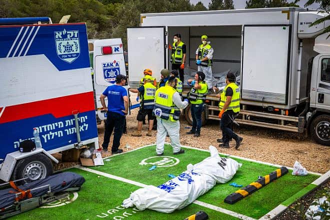 ZAKA emergency response personnel remove the corpses of civilians murdered by Hamas terrorists near Israel's border with Gaza, Oct. 9, 2023. Photo by Yossi Aloni/Flash90.