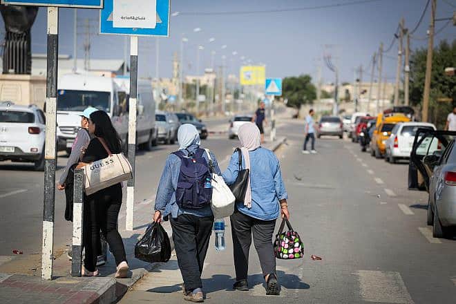 Palestinians who flee from their homes wait at the Rafah border crossing to Egypt in the southern Gaza Strip, on Oct. 14, 2023. Photo by Atia Mohammed/Flash90.