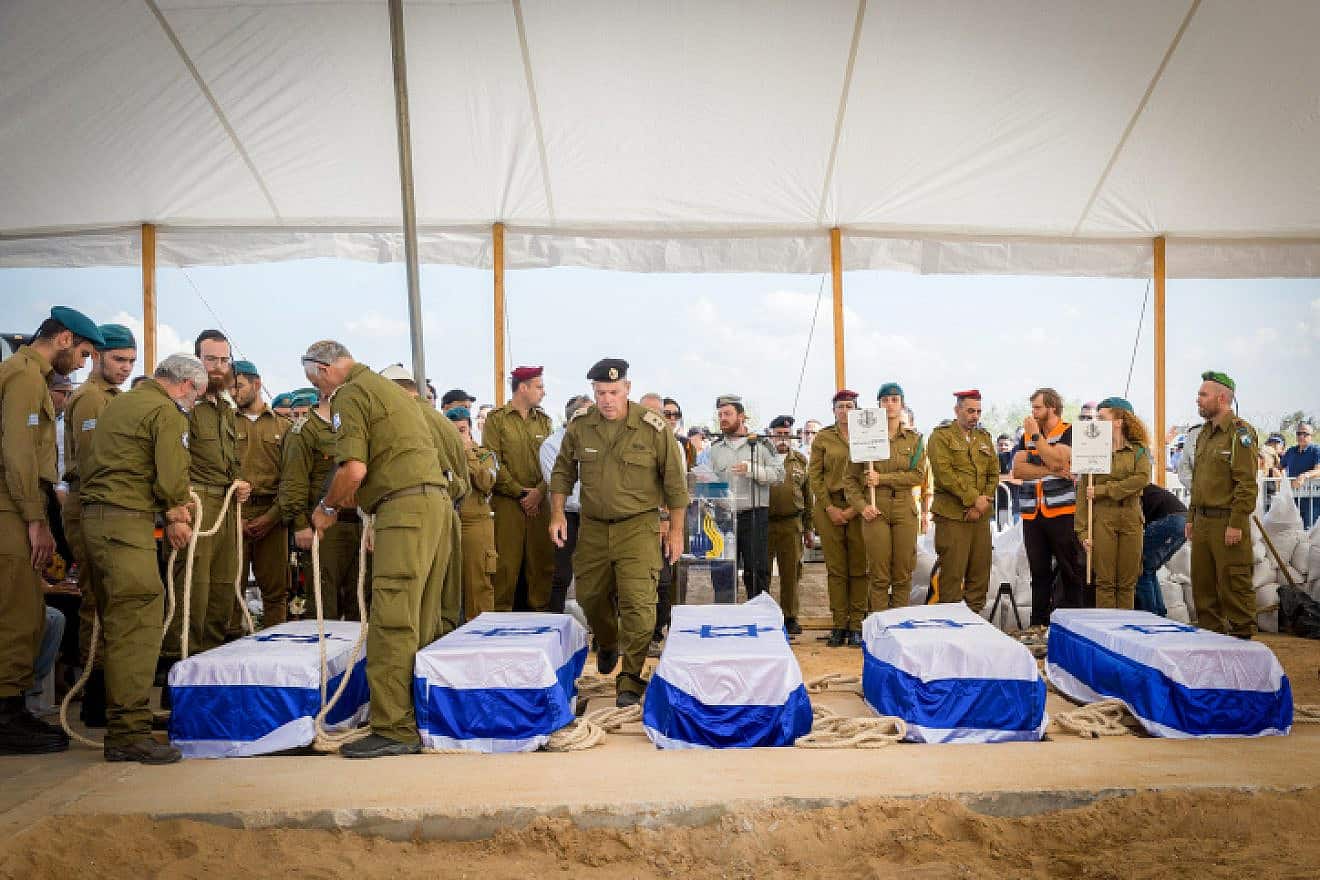 Mourners attend the funeral of five members of the Kotz family, murdered by terrorists on Oct. 7 in Kfar Aza, on Oct. 17, 2023. Photo by Flash90.