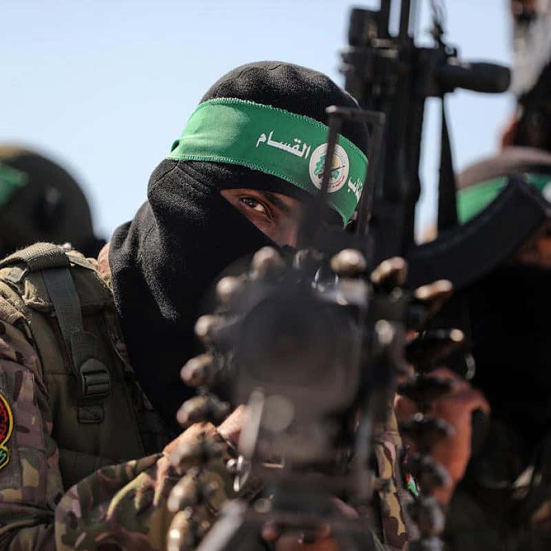 Hamas terrorists march along the border fence between Israel and the Gaza Strip, July 19, 2023. Photo by Majdi Fathi/TPS.