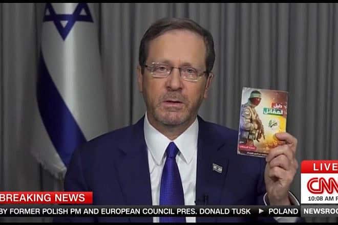 Israeli President Isaac Herzog presents a Hamas terror manual during a "CNN" interview, Oct. 15, 2023. Source: Screenshot.