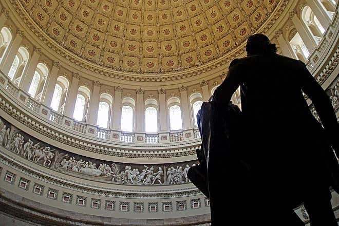 The interior of the U.S. Capitol rotunda from behind a statue of founding father and first president George Washington. The image captures a portion of Constantino Brumidi's “Frieze of American History” starting from “Pizarro Going to Peru” to the beginning of “Landing of the Pilgrims.” Credit: Matt Wade Photography via Wikimedia Commons.
