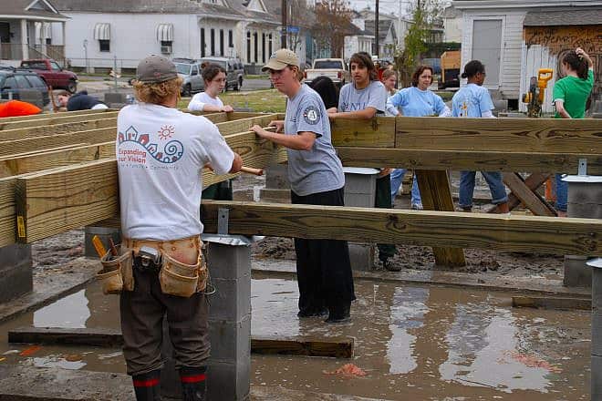 Volunteers from AmeriCorps place a floor joist on a Habitat for Humanity home being built in New Orleans, Jan. 21, 2006. Credit: Marvin Nauman/FEMA Photo Library via Wikimedia Commons.