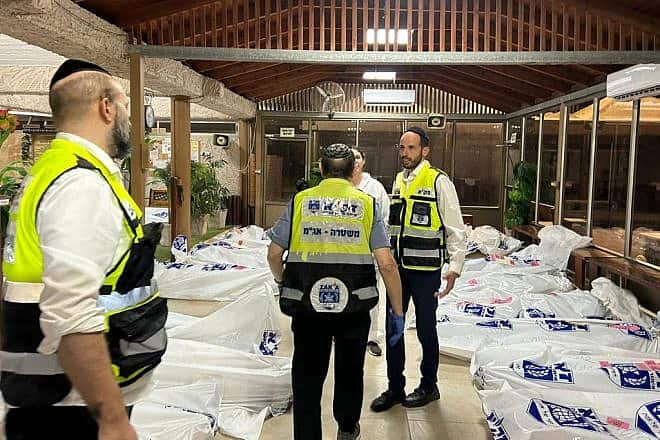 ZAKA search and rescue volunteers at Kibbutz Be'eri identify the bodies of Israelis slain by Hamas terrorists from Gaza, Oct. 11, 2023. Credit: ZAKA.