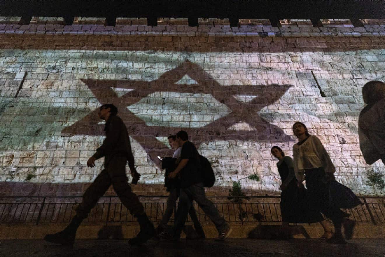 The Israeli flag is projected on the walls of Jerusalem's Old City, Nov. 7, 2023. Photo by Chaim Goldberg/Flash90.