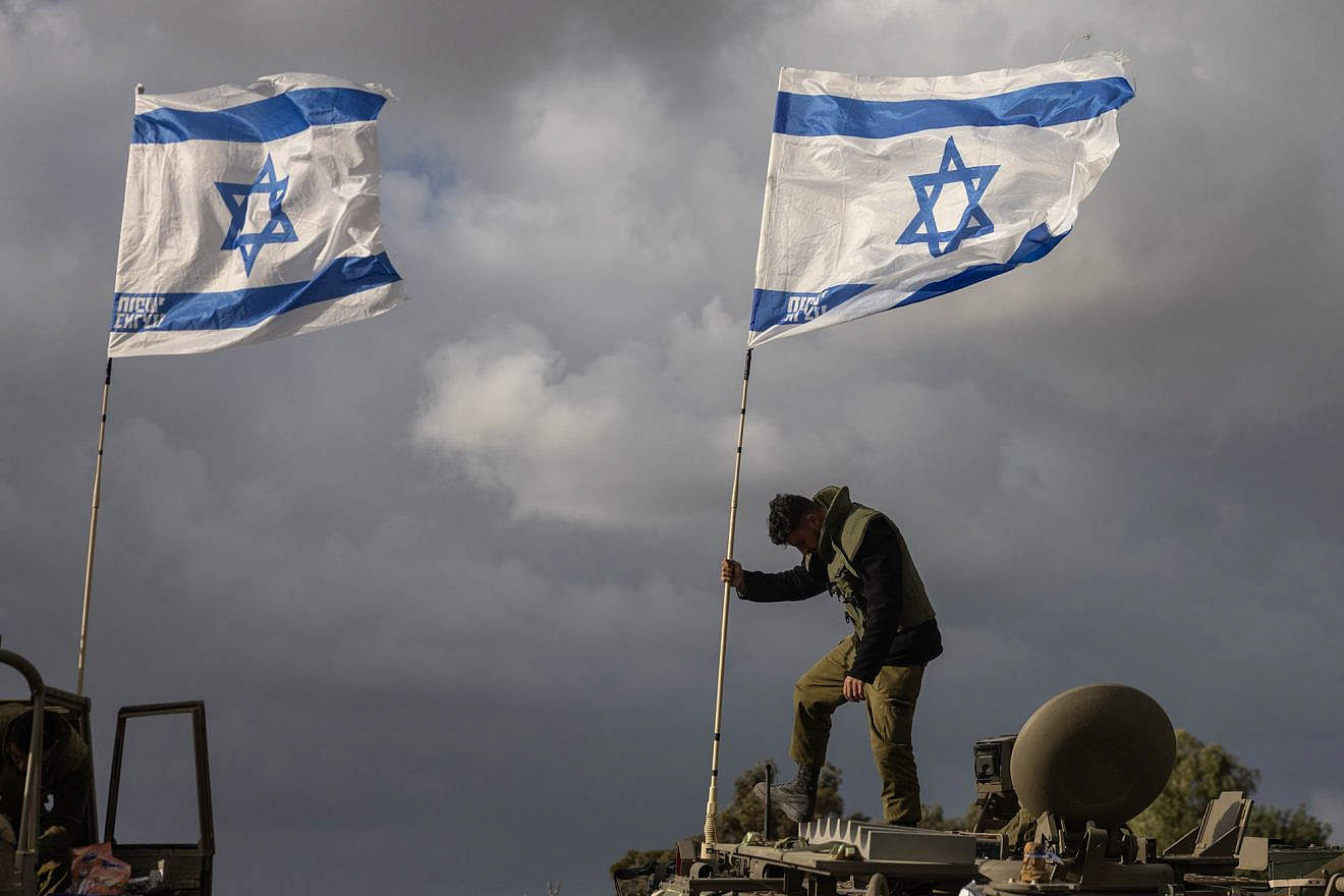 A convoy of armored personnel carriers is seen near the Gaza border, Nov. 20, 2023. Photo by Chaim Goldberg/Flash90.