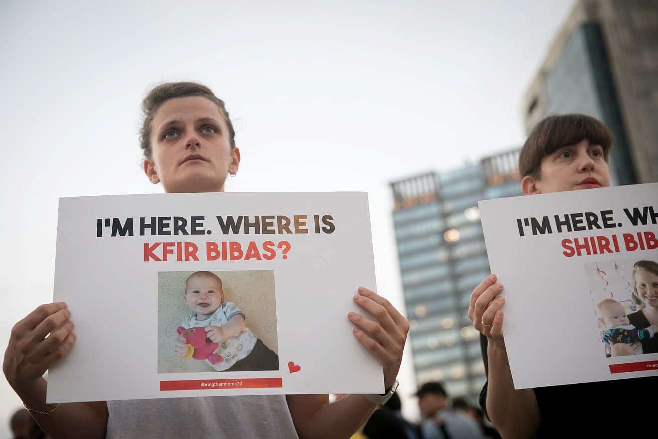 Israelis hold photographs of a mother and child held captive by Hamas terrorists in Gaza, outside the Tel Aviv Museum of Art, Nov. 2, 2023. Photo by Miriam Alster/Flash90.