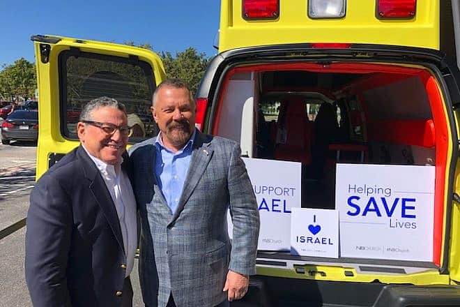 Richard Zelin (left) and Pastor Larry Huch next to a Mobile Intensive Care Unit ambulance sponsored by New Beginnings Church in 2019. Credit: Courtesy.
