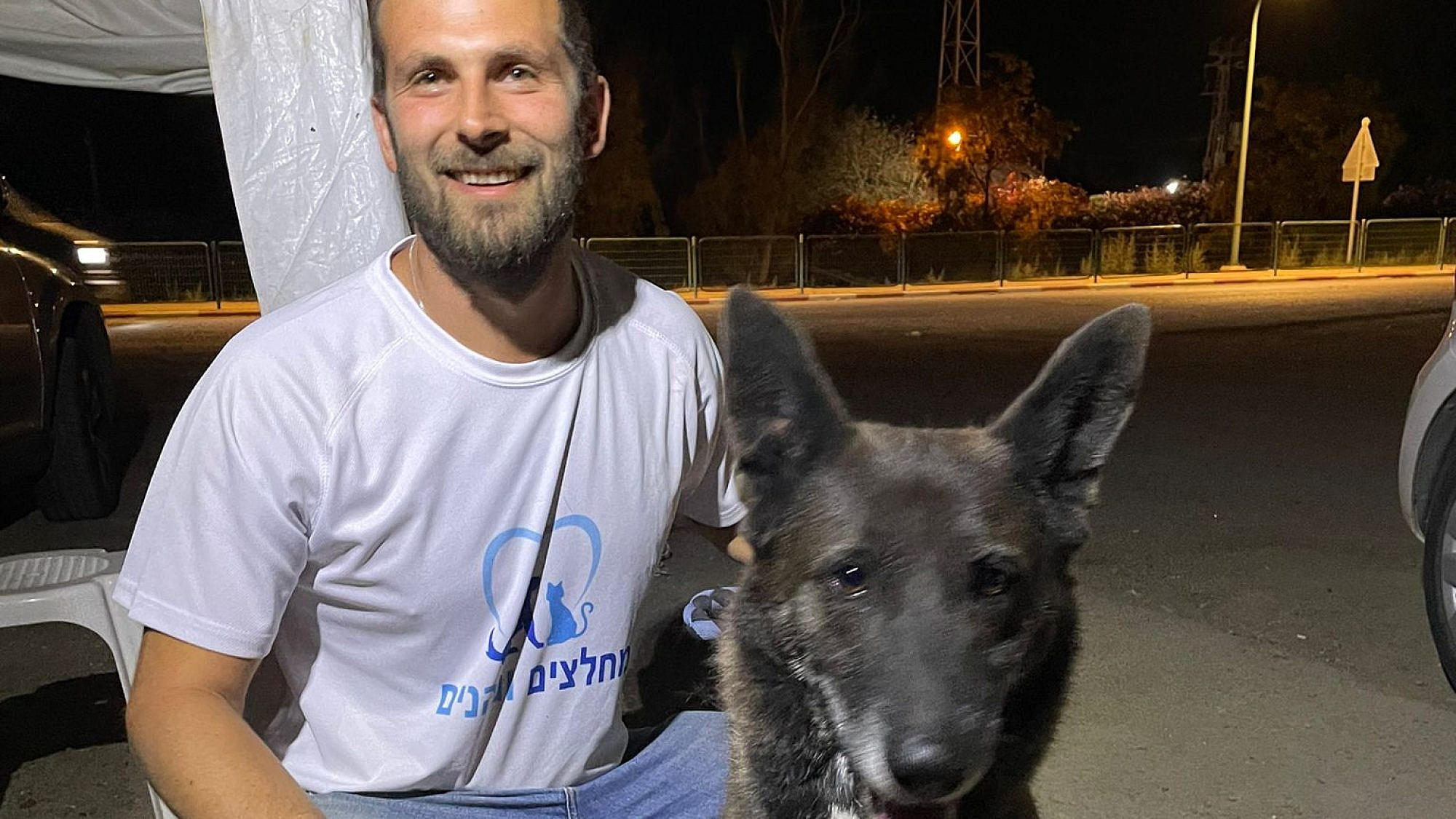 Adam Benett rescues a dog at a kibbutz in southern Israel. Credit: Courtesy.