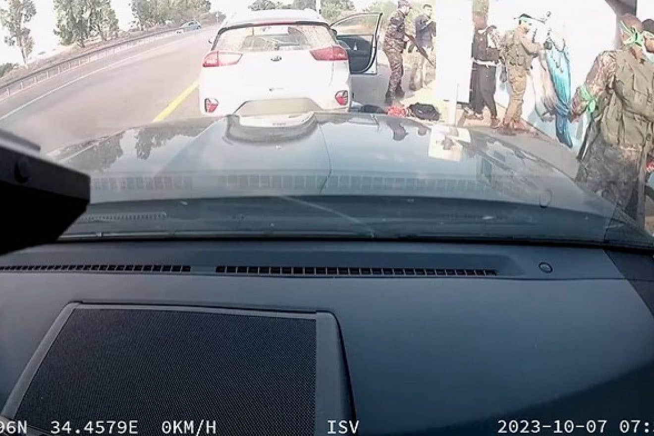 Screenshot from video of Hamas terrorists outside of a public bomb shelter full of people attending the Nova music festival near Re'im, Oct. 7, 2023. Source: X.