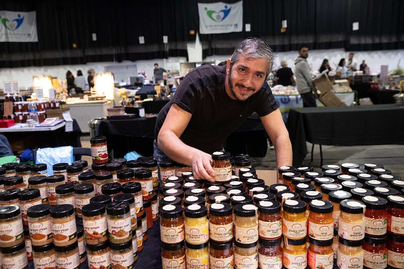 A business owner at the Hangar 11 Fair at the Tel Aviv Port, December 2023. Photo by Yoav Lin.