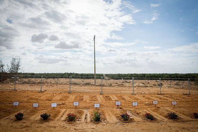 Graves of Israelis who were murdered by Hamas terrorists on Oct. 7 in Kibbutz Be'eri, Nov. 15, 2023. Photo by Chaim Goldberg/Flash90.