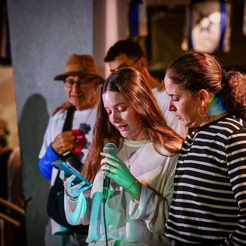 Chen Goldstein-Almog and her daughter Agam light Chanukah candles together with other members of Kibbutz Kfar Aza in Shefayim, Dec. 10, 2023. Photo by Avshalom Sassoni/Flash90.