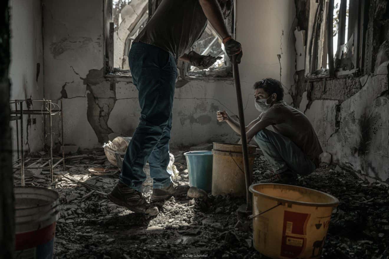 Members of a family whose father was murdered by Hamas terrorists on Oct. 7 search the rubble of his home in Kibbutz Be'eri on Nov. 30, 2023. Photo by Chen Schimmel/Flash90.