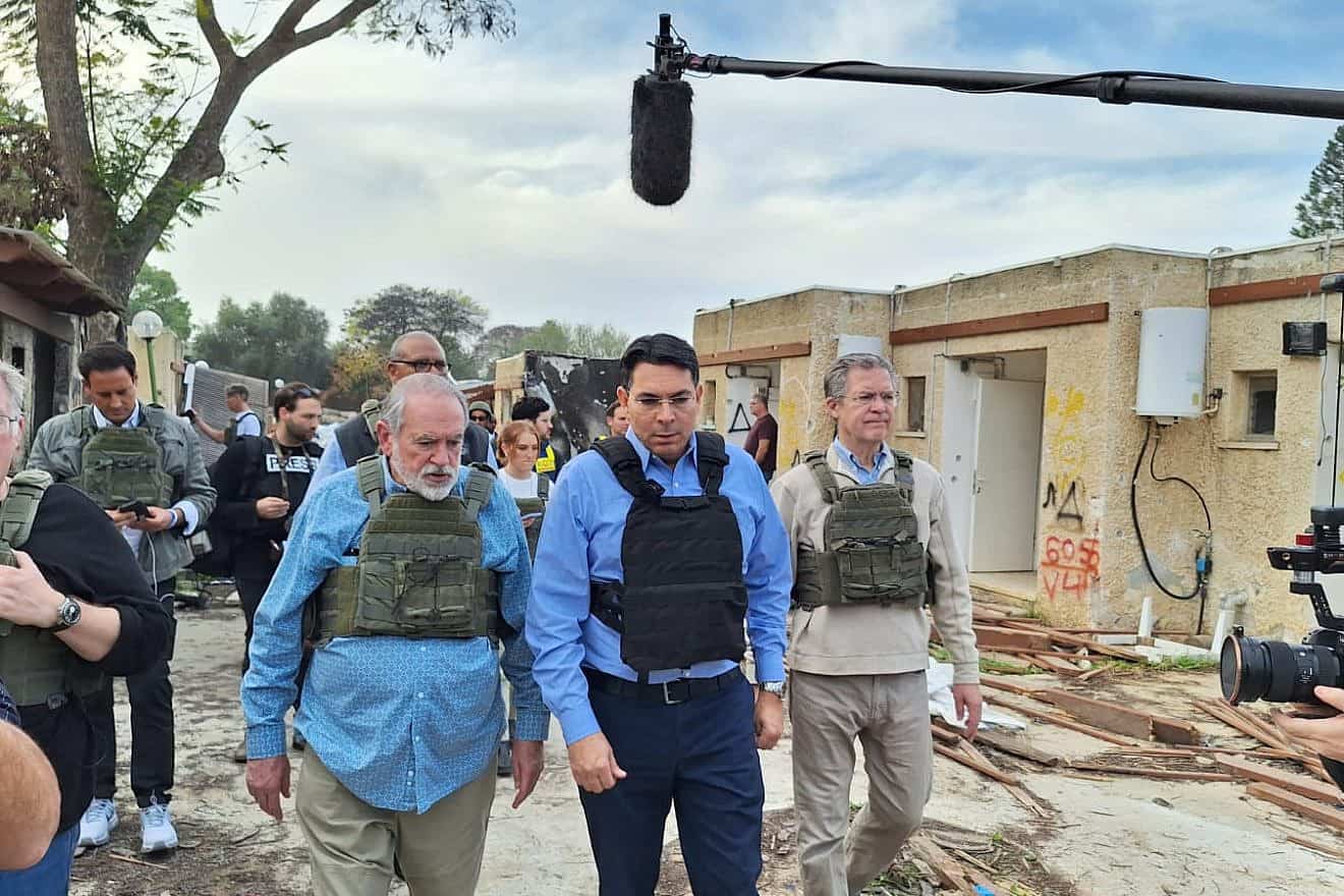 Former Arkansas Governor Mike Huckabee (left), MK Danny Danon (center) and former Kansas Governor Sam Brownback (right) at Kibbutz Kfar Aza, Dec. 20, 2023. Credit: Courtesy.