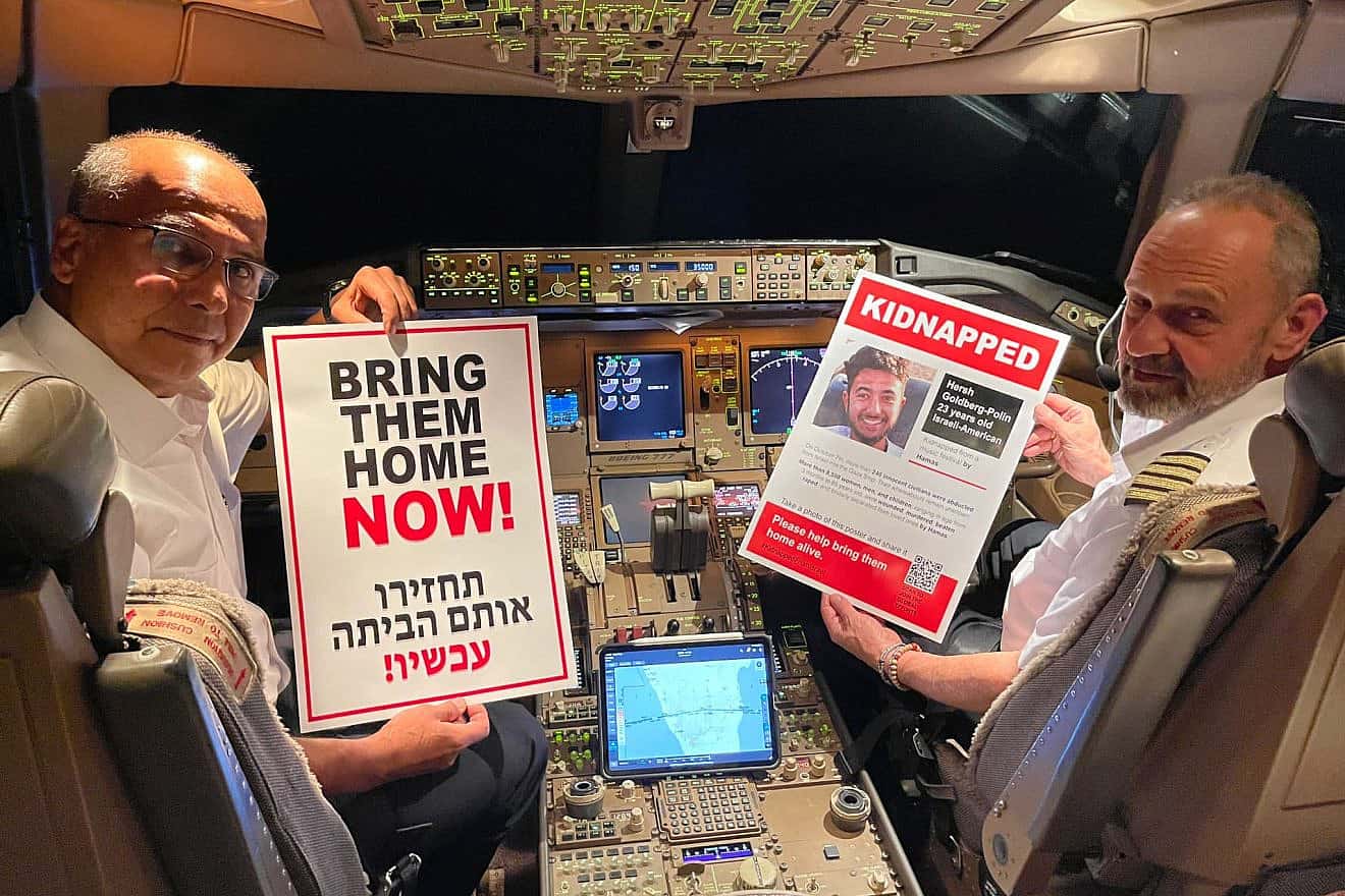 Pilots hold posters of Hamas captive Hersh Goldberg-Polin on the flight he would have taken on a planned trip to Southeast Asia. Credit: Courtesy of Matt Krieger.