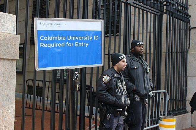 NYPD officers next to sign requiring ID in front of Columbia University's main gate on Nov. 15, 2023 during a protest after the suspension of anti-Israel student groups. Credit: Here Now/Shutterstock.