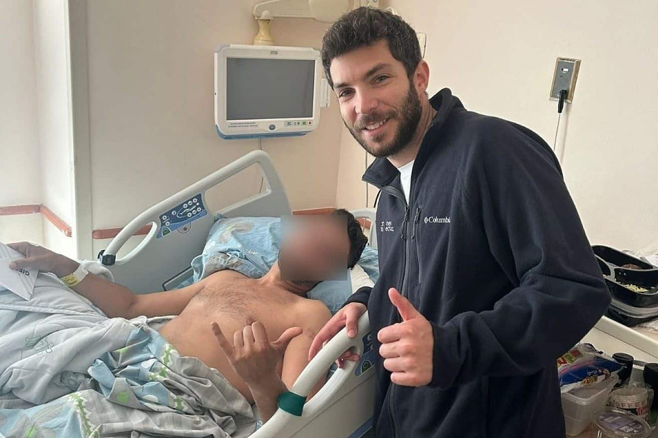 Shachar, an IDF reservist injured in Gaza, with Belev Echad volunteer Gal Rosenberg, who was also once wounded in battle, at Beilinson Hospital in Petach Tikvah. Credit: Belev Echad.