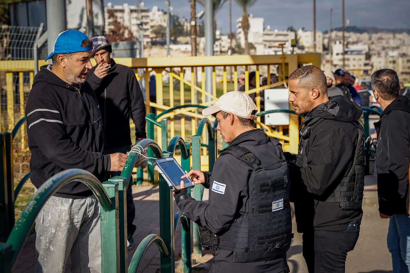 Palestinian workers enter the Israeli town of Ma’aleh Adumim following an attempted stabbing attack, Feb. 23, 2023. Photo by Erik Marmor/Flash90.
