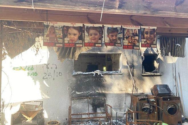 Posters of Sharon Aloni-Cunio, David Cunio, their twin daughters Emma and Yuli, and Sharon's niece Emilia Aloni near their home in Nir Oz, Jan. 16, 2024. Photo by Amelie Botbol.