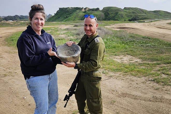 Archaeologist Sarah Tal from the Israel Antiquities Authority and Lt. Col. Yair Amitsur with the grinding mortar. Photo by Ilon Glick.