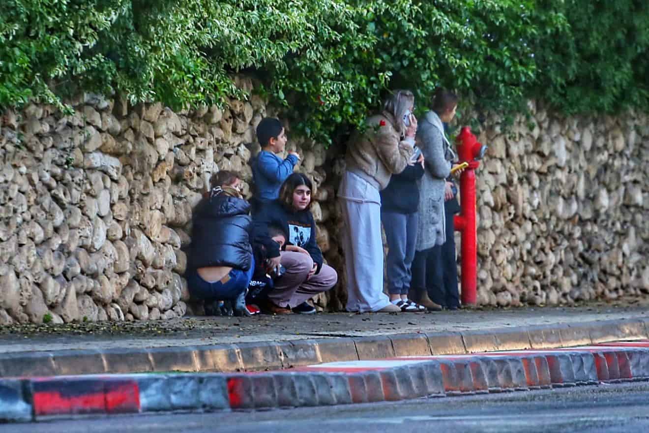 Israelis take cover as a rocket warning siren sounds in Kiryat Ono, a suburb of Tel Aviv, Jan. 29, 2024. Photo by Eitan Elhadaz/TPS.