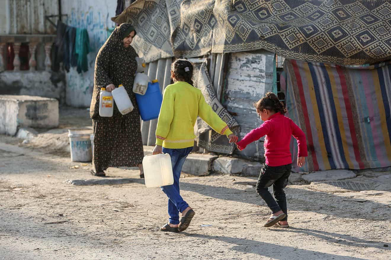 Palestinians fill water from pipes provided by the U.N. Relief and Works Agency in the Rafah refugee camp, Southern Gaza Strip on Jan. 25, 2023. Photo by Abed Rahim Khatib/Flash90.